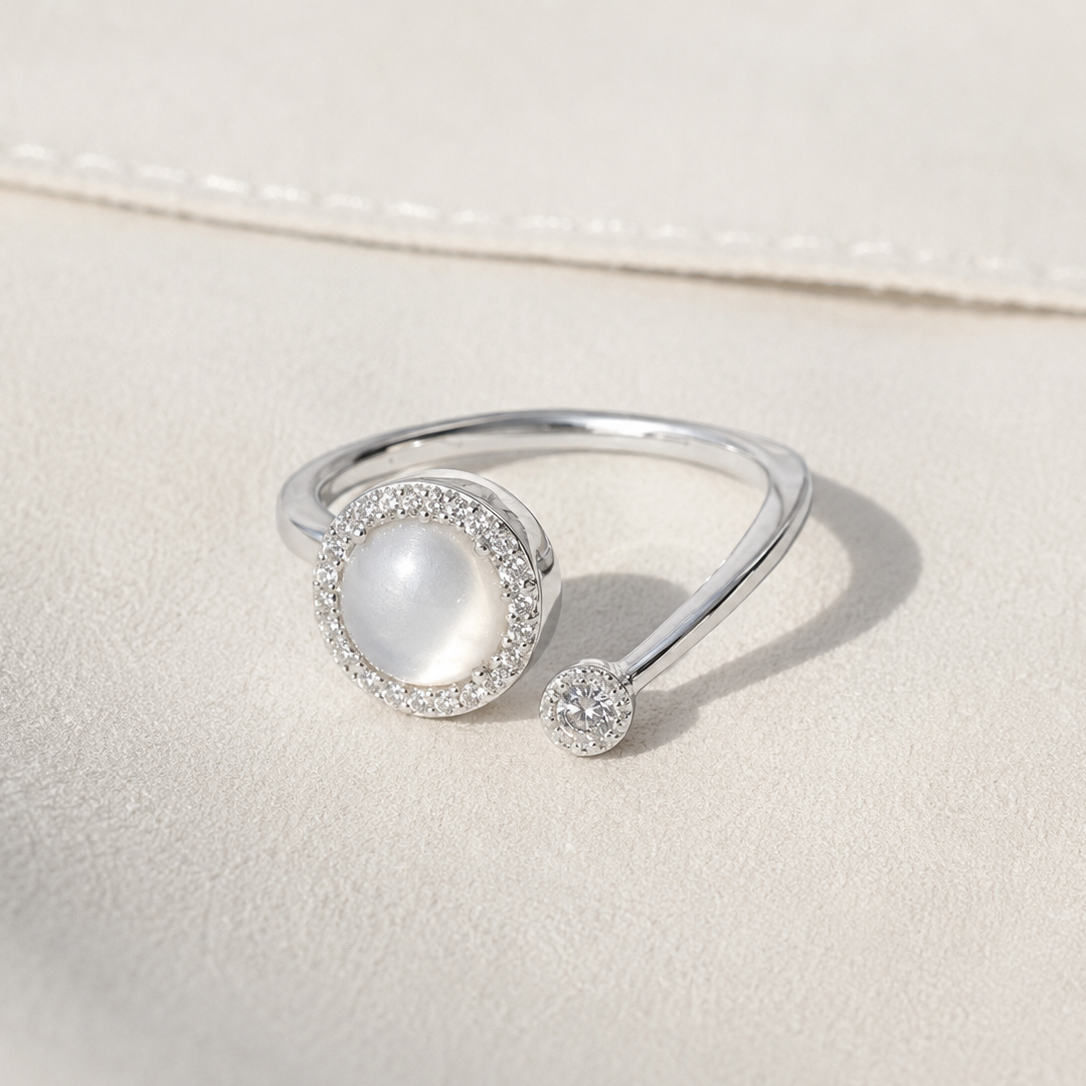 Silver ring with a pearl on a light beige background