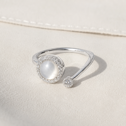 Silver ring with a pearl on a light beige background