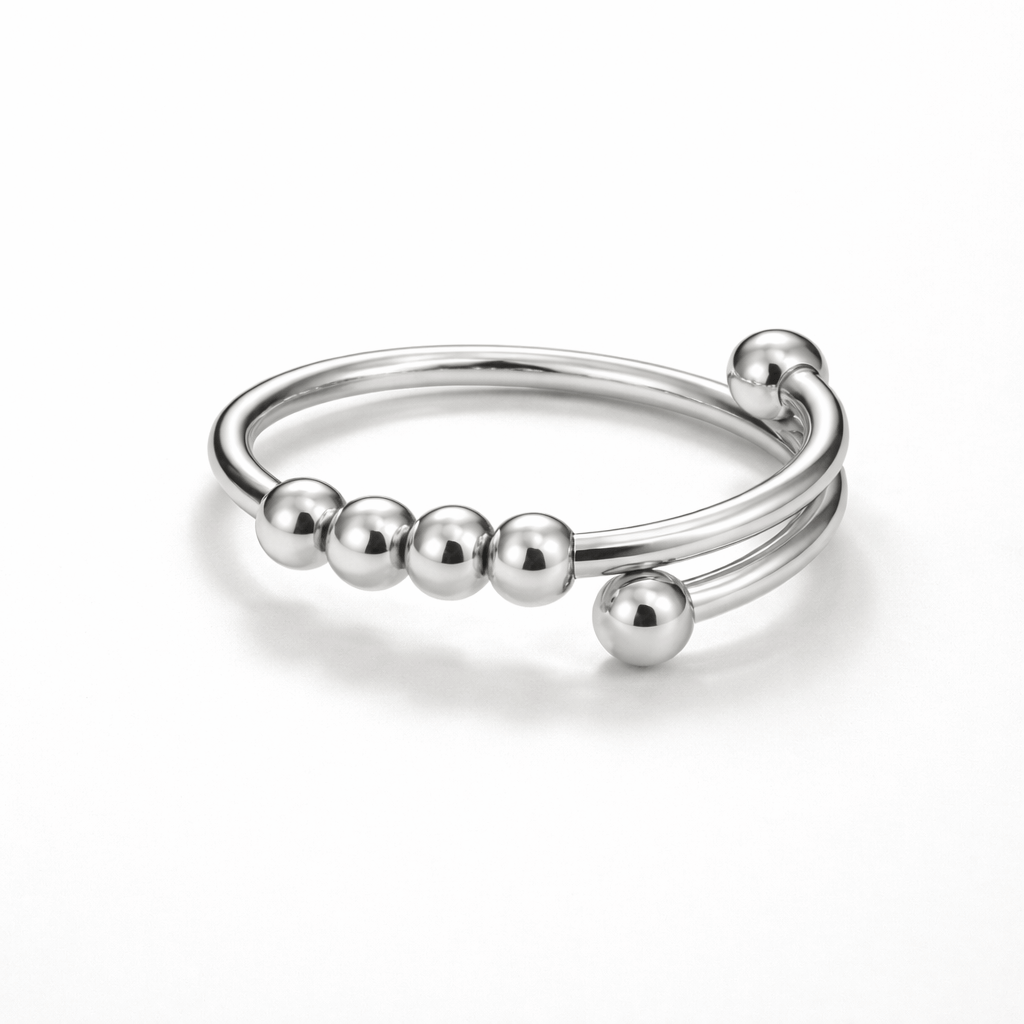 Silver ring with bead-like nodes on a white background
