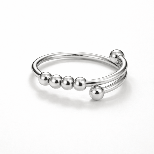 Silver ring with bead-like nodes on a white background