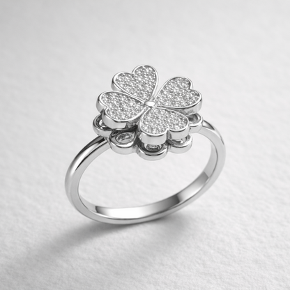 Silver anxiety spinner flower ring on a light gray background