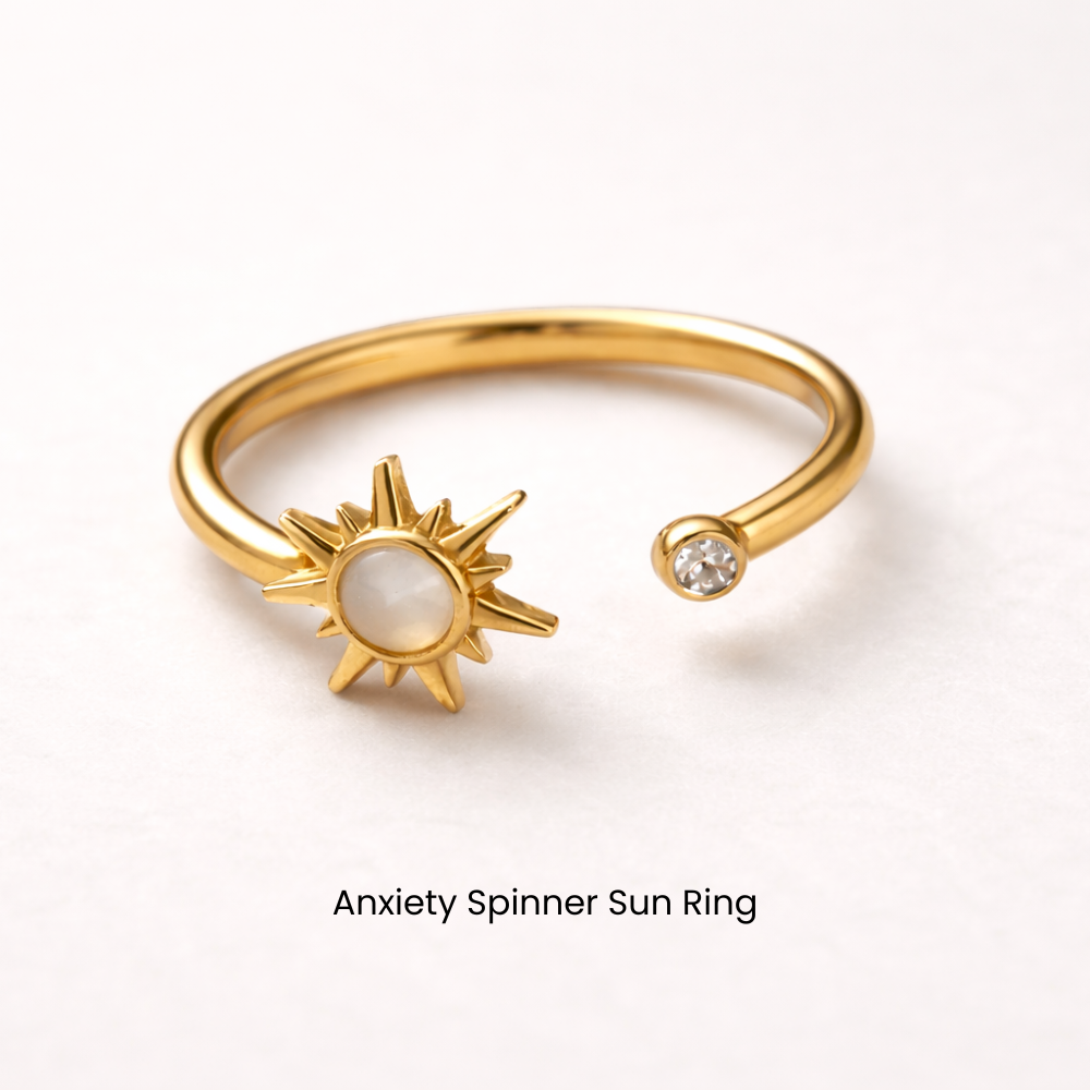Gold anxiety spinner sun ring on a white background