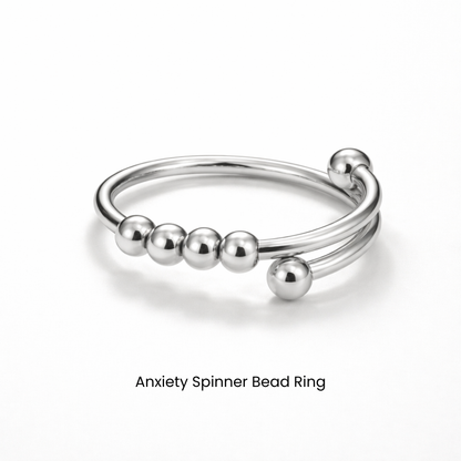 Silver anxiety spinner bead ring on a white background