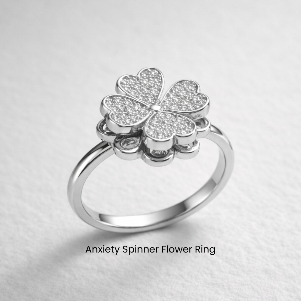 Silver anxiety spinner flower ring on a light gray background