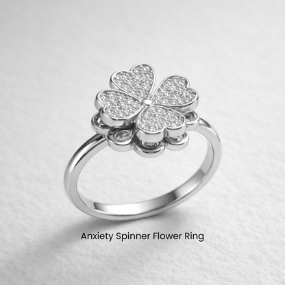 Silver anxiety spinner flower ring on a light gray background