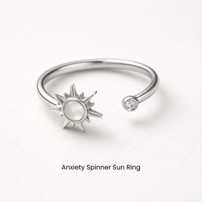 Silver anxiety spinner sun ring on a white background