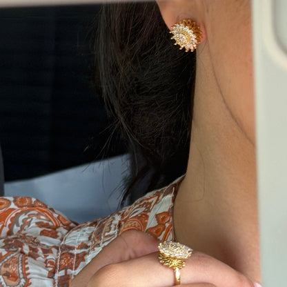 Stressy protea earings brass close up image.